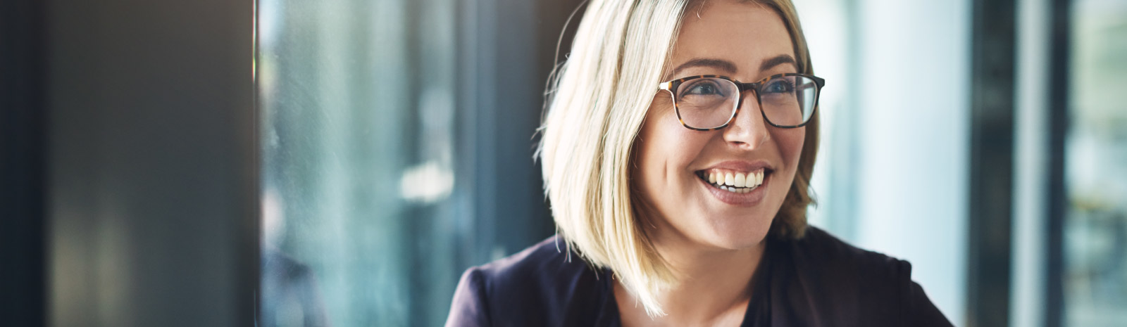 young woman with glasses smiling
