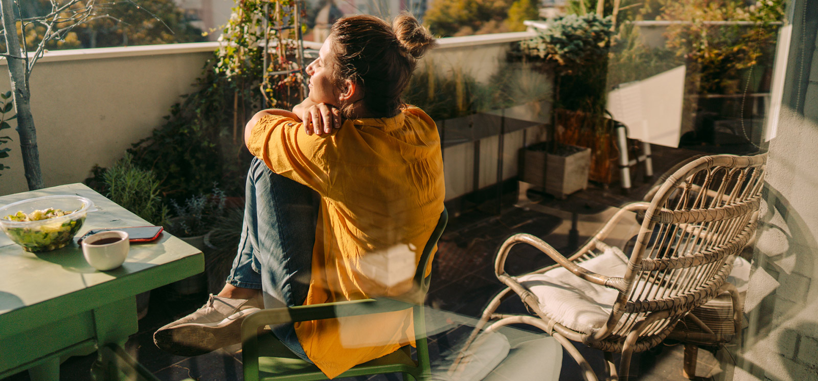 Woman enjoying the patio view and coffee.