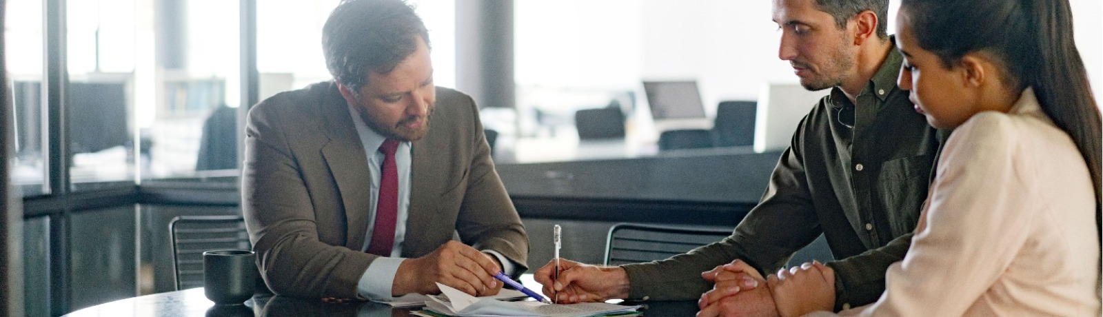 a couple reviewing documents with their lender